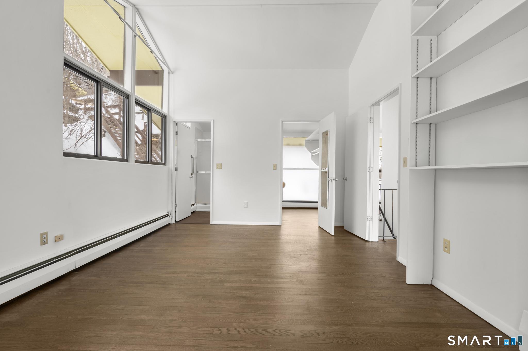 304 Olmstead Hill Road Wilton, CT 06897 - Photo 26 of 35 a view of an empty room with a window and wooden floor