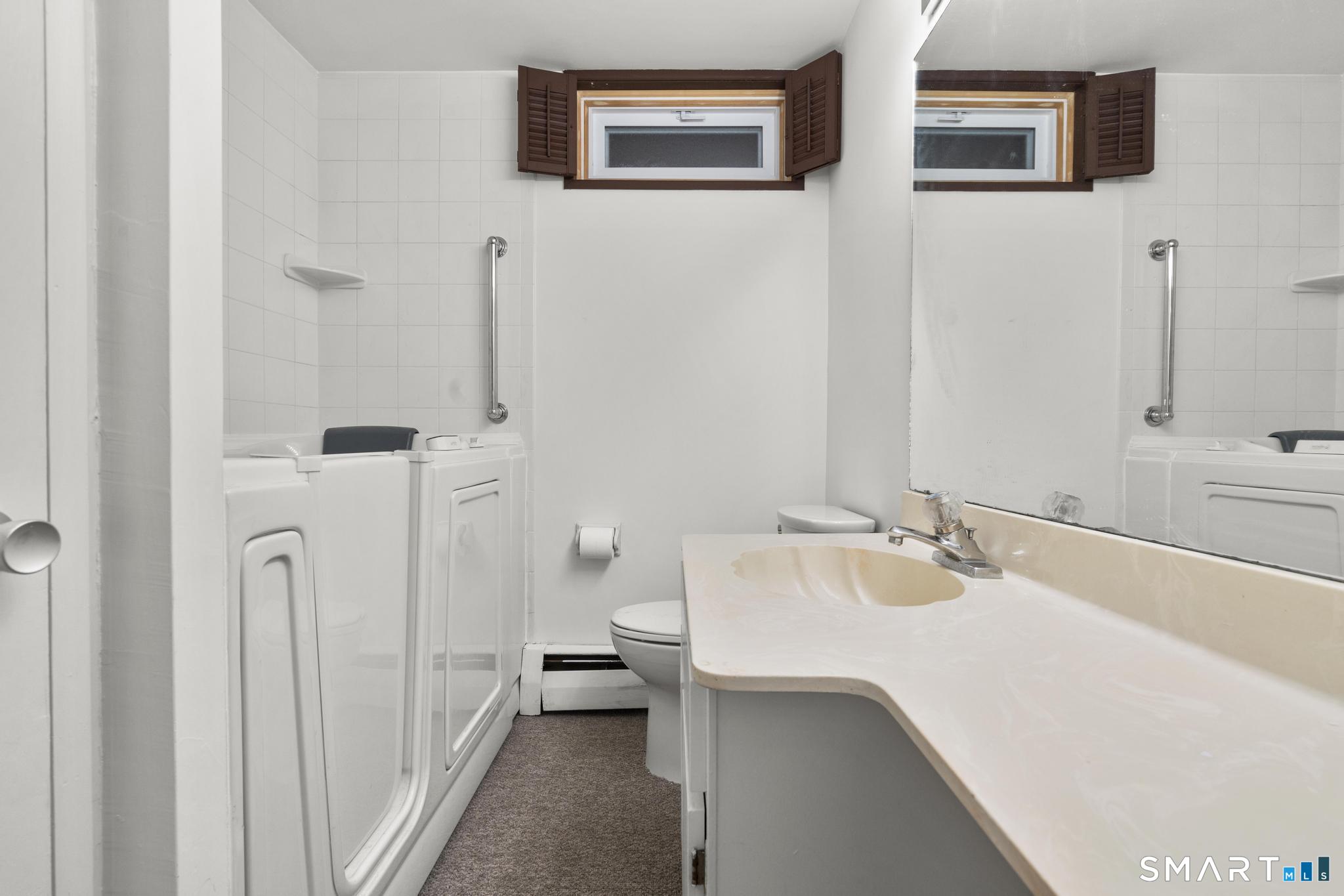 304 Olmstead Hill Road Wilton, CT 06897 - Photo 32 of 35 a bathroom with a sink and a mirror