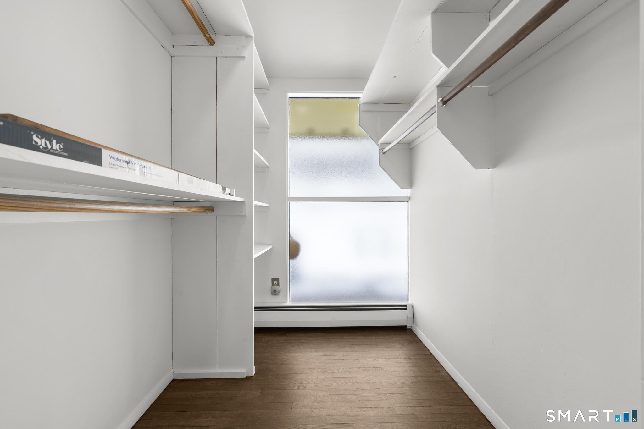 304 Olmstead Hill Road Wilton, CT 06897 - Photo 34 of 35 a view of an empty room with wooden floor and a window