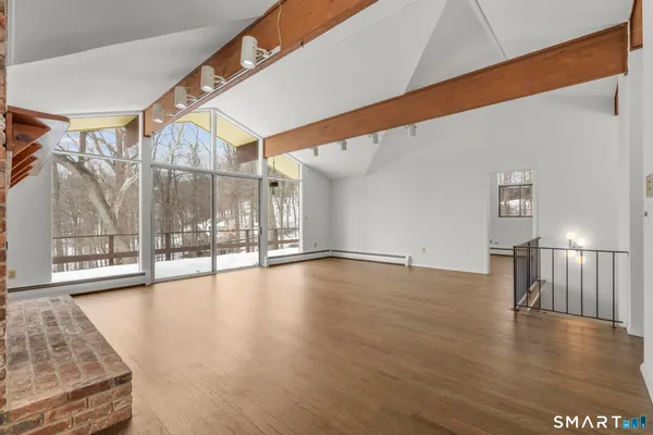 a view of an empty room with glass door