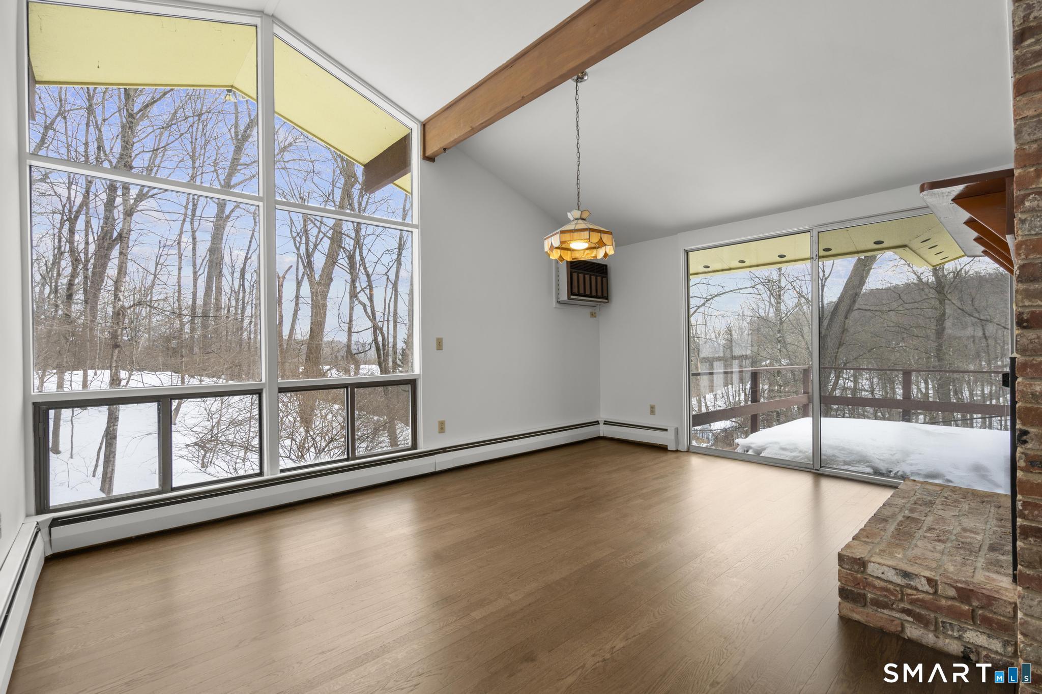 304 Olmstead Hill Road Wilton, CT 06897 - Photo 6 of 35 a view of an empty room and window with wooden floor
