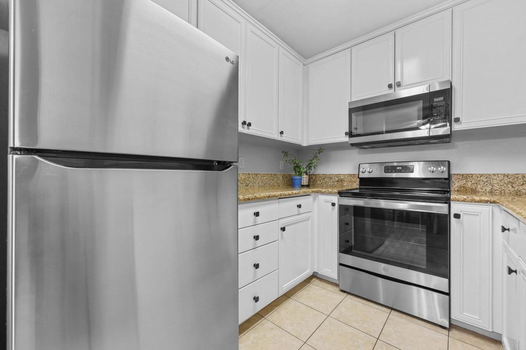 1423 Graves Avenue, Unit 238 El Cajon, CA 92021 - Photo 11 of 25 a kitchen with white cabinets and stainless steel appliances