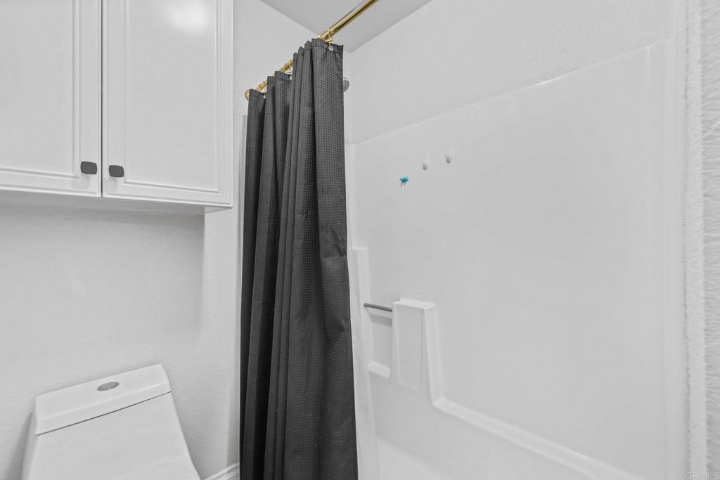 1423 Graves Avenue, Unit 238 El Cajon, CA 92021 - Photo 17 of 25 a bathroom with a shower and a toilet