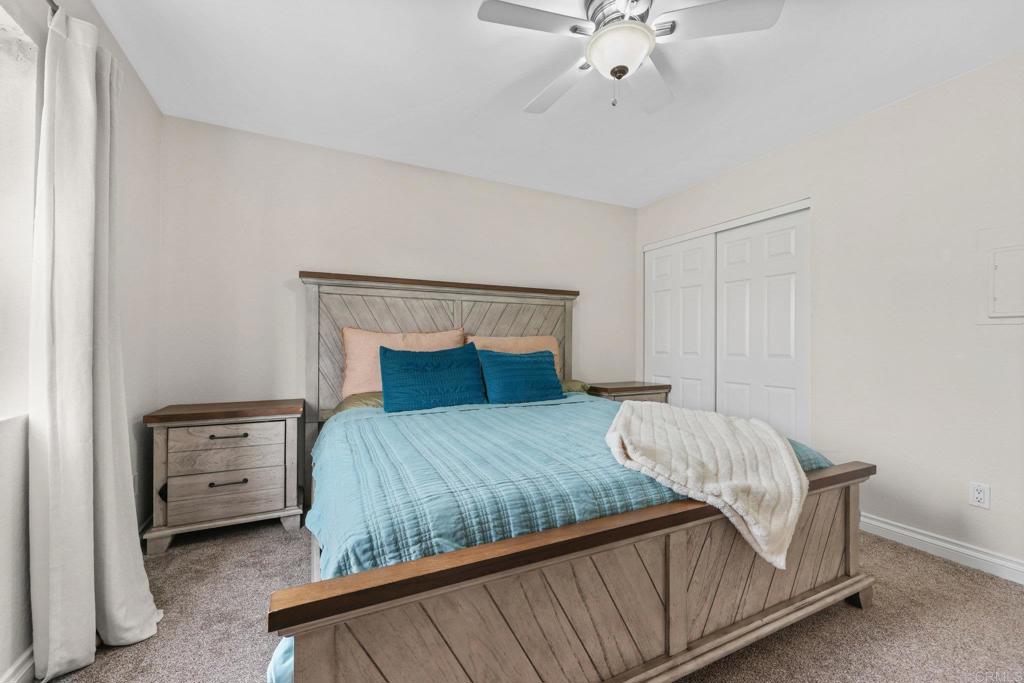 1423 Graves Avenue, Unit 238 El Cajon, CA 92021 - Photo 24 of 25 a bedroom with a bed and a chandelier