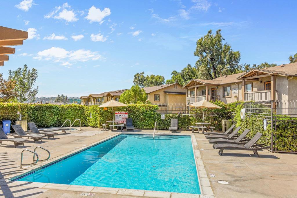 1423 Graves Avenue, Unit 238 El Cajon, CA 92021 - Photo 25 of 25 a view of a white house with a yard patio and swimming pool