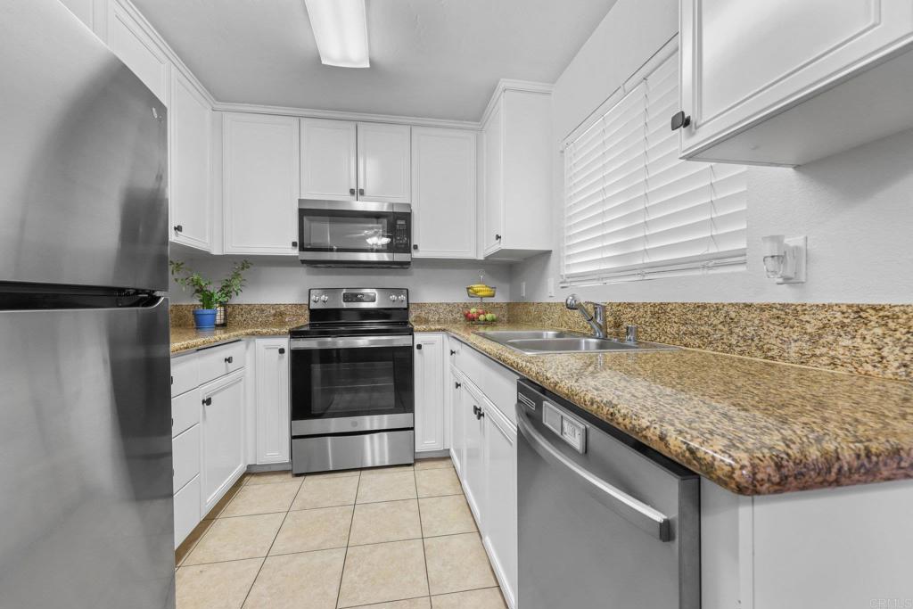 1423 Graves Avenue, Unit 238 El Cajon, CA 92021 - Photo 10 of 25 a kitchen with granite countertop a stove sink and cabinets