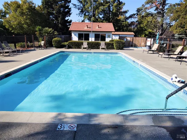 a front view of house with yard and car parked