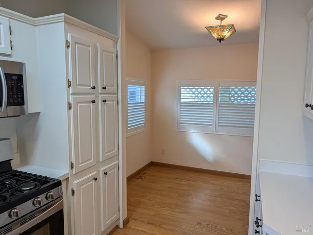 a view of a livingroom with wooden floor and a window