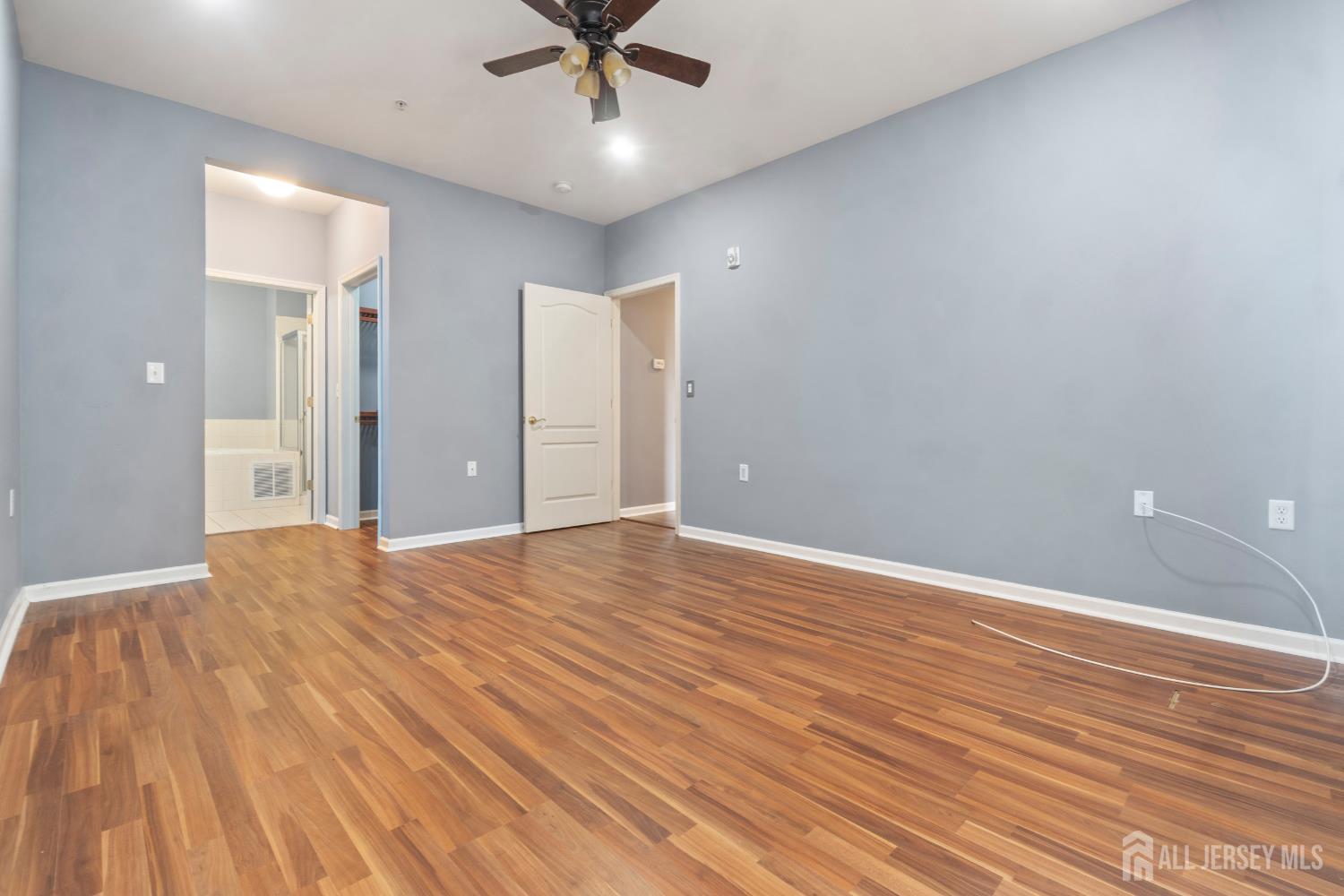 41 Azalea Drive Old Bridge, NJ 08857 - Photo 11 of 18 an empty room with wooden floor and windows