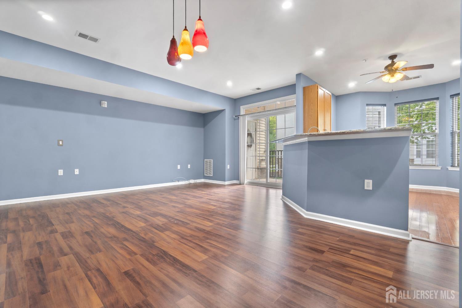 41 Azalea Drive Old Bridge, NJ 08857 - Photo 4 of 18 a view of an empty room with window and wooden floor