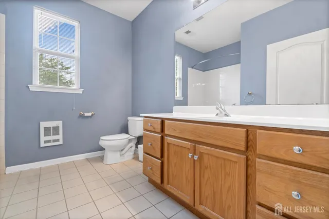 a bathroom with a sink mirror and toilet