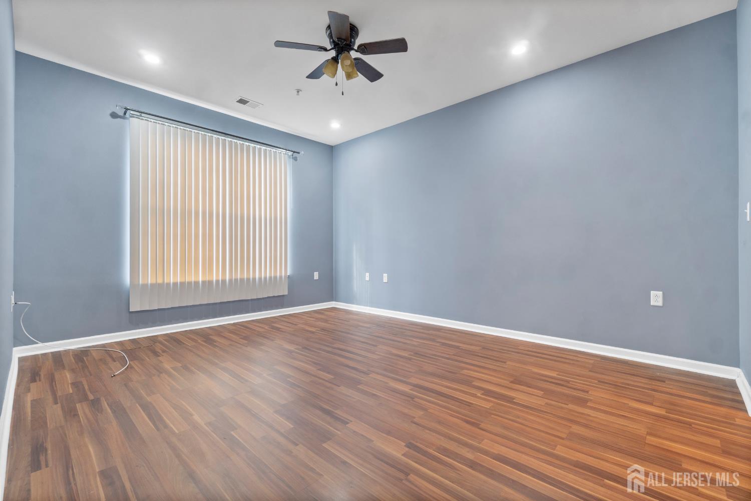 41 Azalea Drive Old Bridge, NJ 08857 - Photo 10 of 18 wooden floor in an empty room with a window