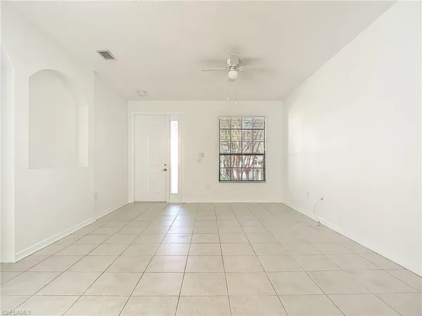 an empty room with wooden floor & bathroom