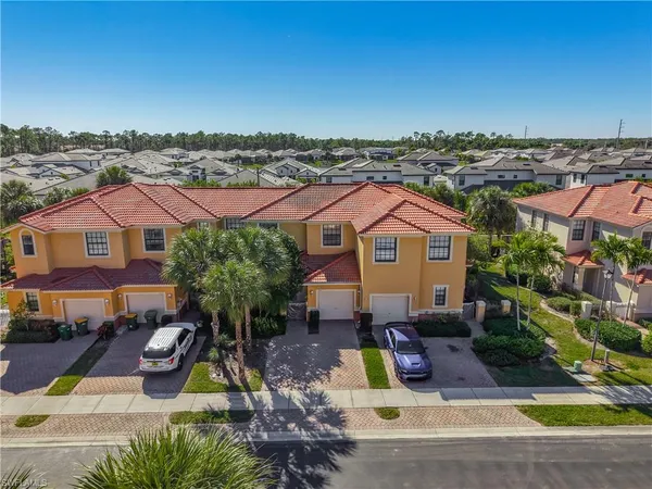 a view of a house with swimming pool and sitting area