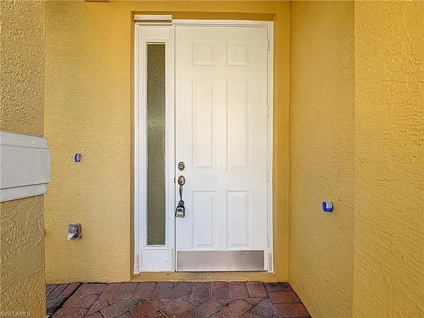an empty room with a ceiling fan and window