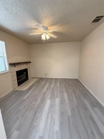 wooden floor in an empty room with a fireplace