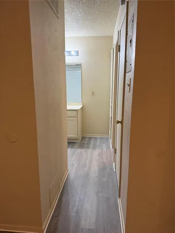 a view of a room with wooden floor