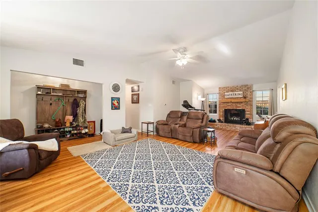 a living room with furniture ceiling fan and a rug