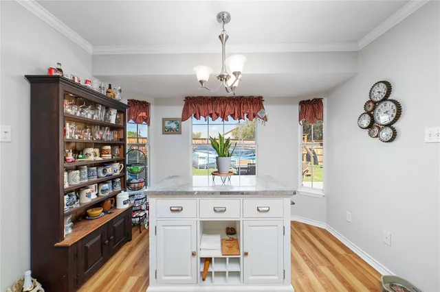 a view of hallway with seating and chandelier