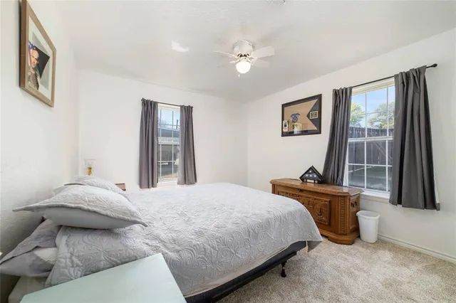 a bedroom with a bed and glass windows