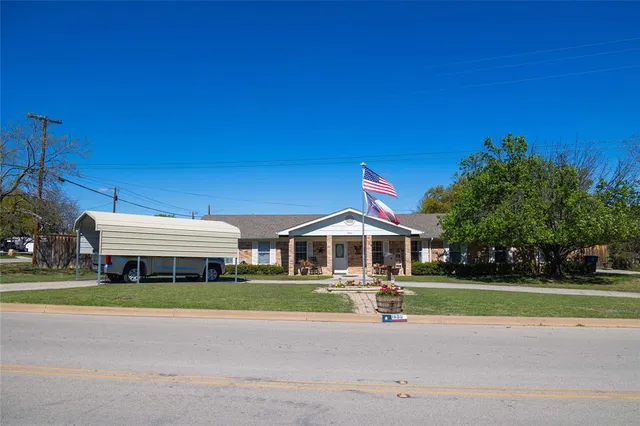 a front view of a house with a yard table and chairs