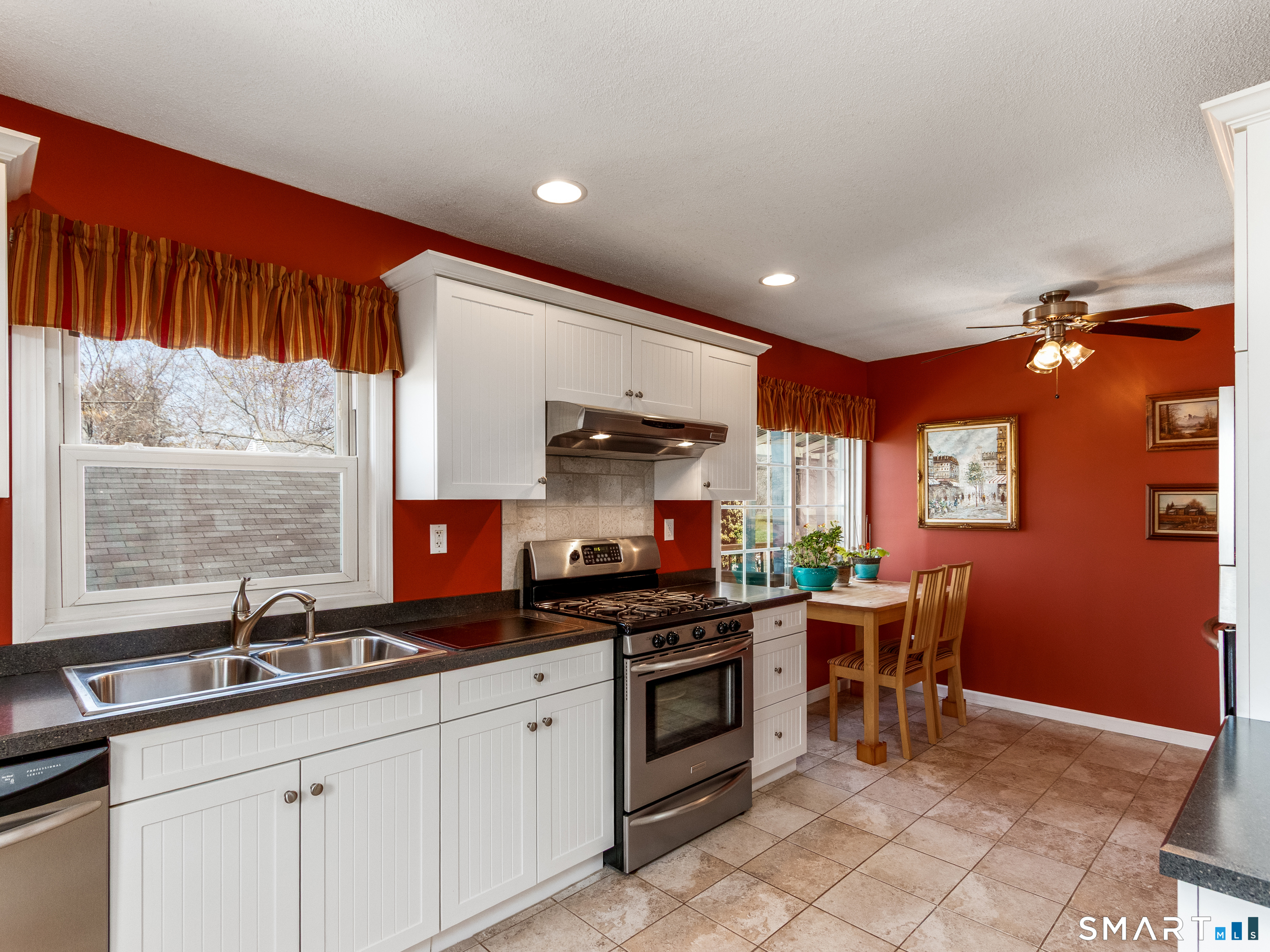 a kitchen with stainless steel appliances kitchen island granite countertop a sink and cabinets