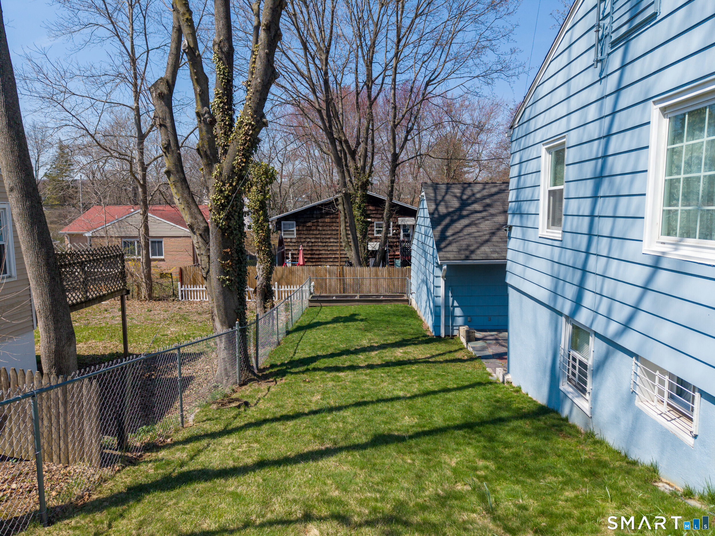 30 Lucy Street Hamden, CT 06514 - Photo 21 of 46 a view of a house with backyard and a tree