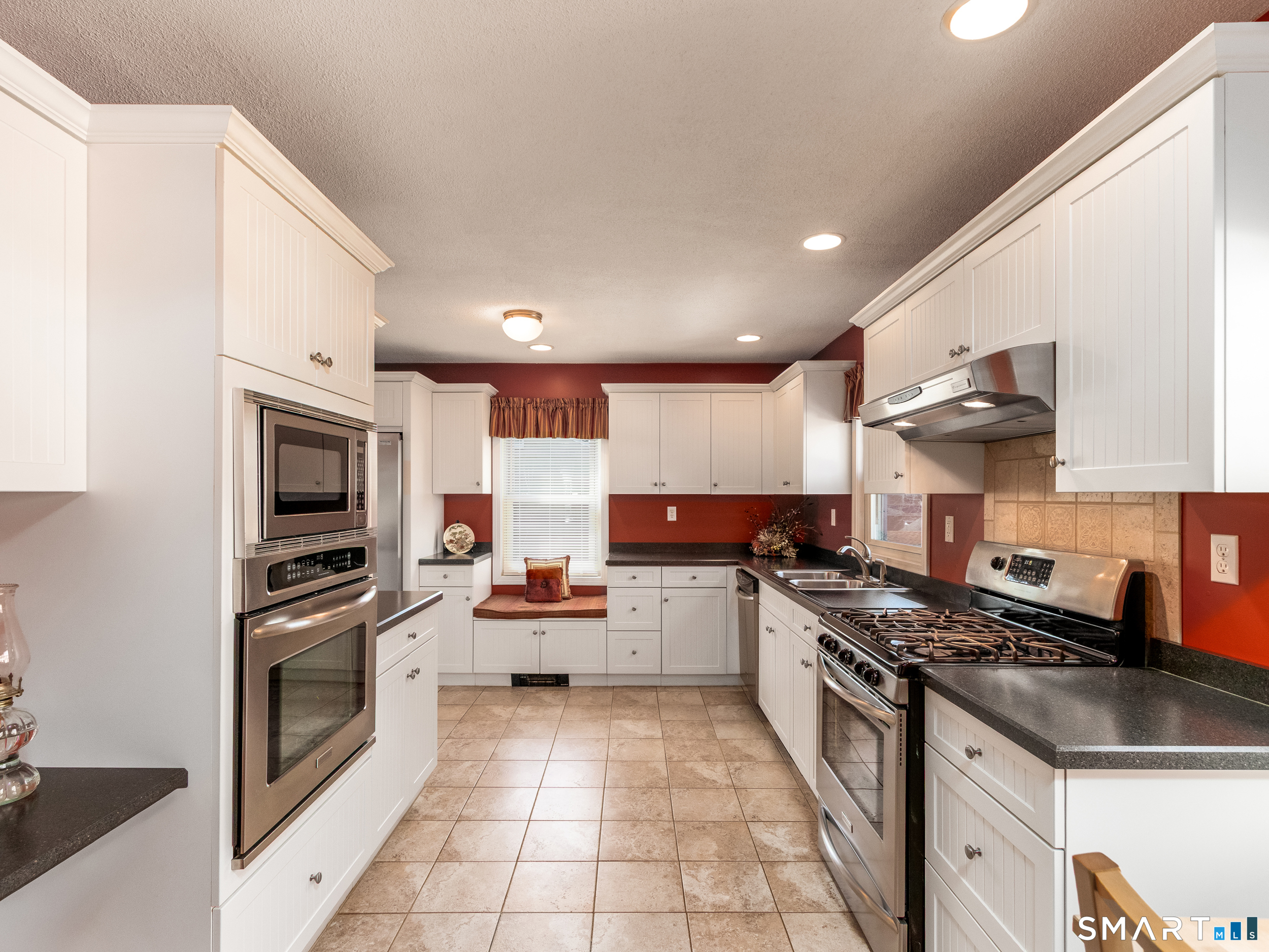 30 Lucy Street Hamden, CT 06514 - Photo 29 of 46 a kitchen with stainless steel appliances granite countertop a stove sink and cabinets