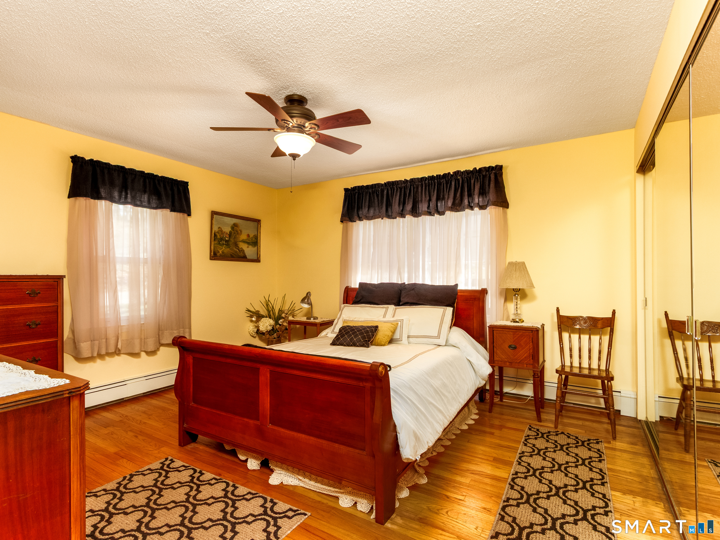 30 Lucy Street Hamden, CT 06514 - Photo 33 of 46 a bedroom with a bed and wooden floor