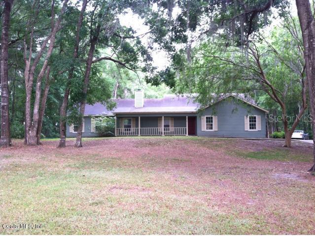 8918 Southeast 19th Avenue Road Ocala, FL 34480 - Photo 1 of 1 a front view of a house with a garden and tree