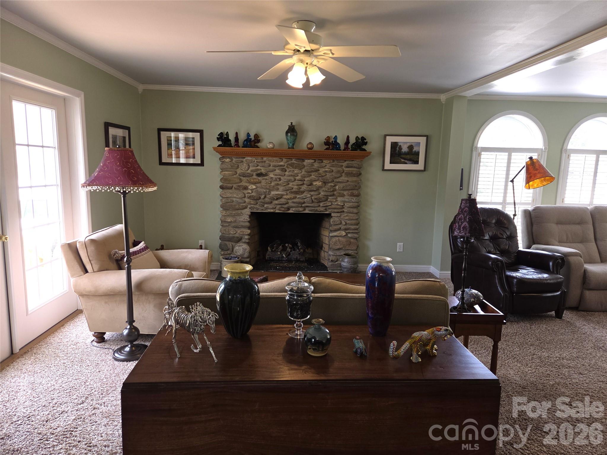 729 Sternbridge Drive Concord, NC 28025 - Photo 11 of 42 a living room with furniture a fireplace and a chandelier