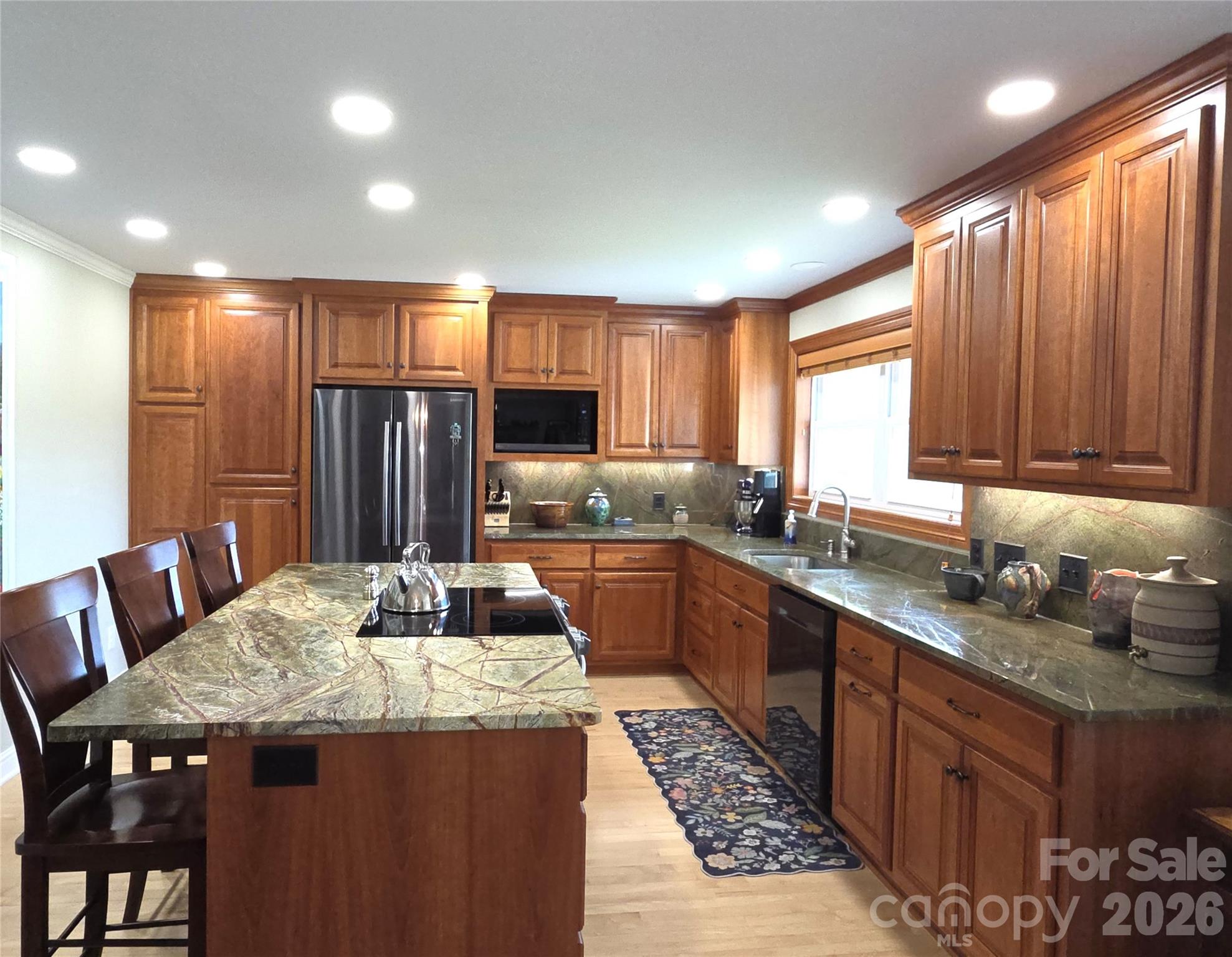 729 Sternbridge Drive Concord, NC 28025 - Photo 13 of 42 a kitchen with granite countertop kitchen island stainless steel appliances a sink table and chairs