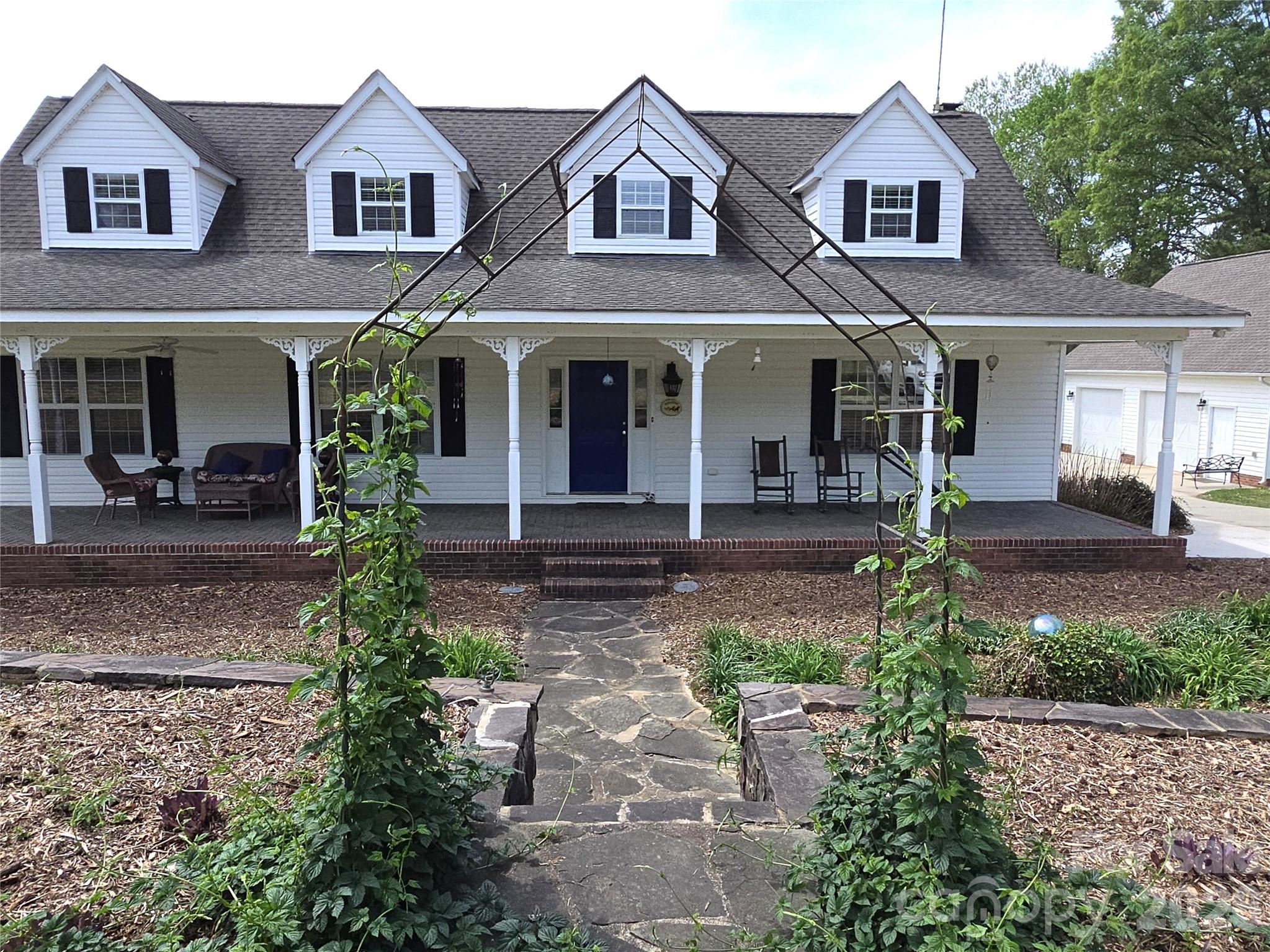 729 Sternbridge Drive Concord, NC 28025 - Photo 2 of 42 a front view of a house with garden