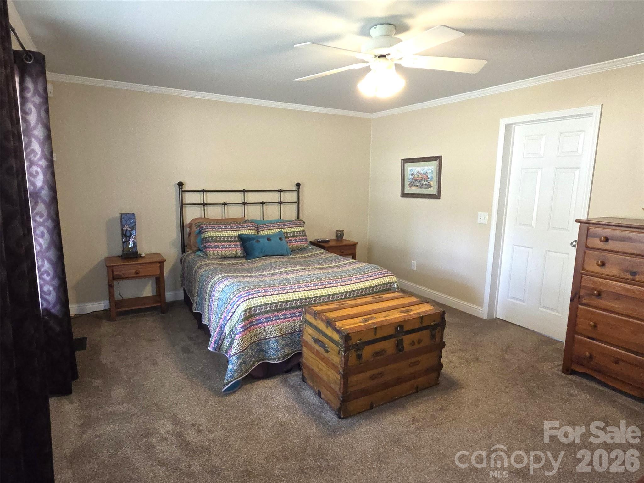 729 Sternbridge Drive Concord, NC 28025 - Photo 21 of 42 a bedroom with a bed and a chandelier