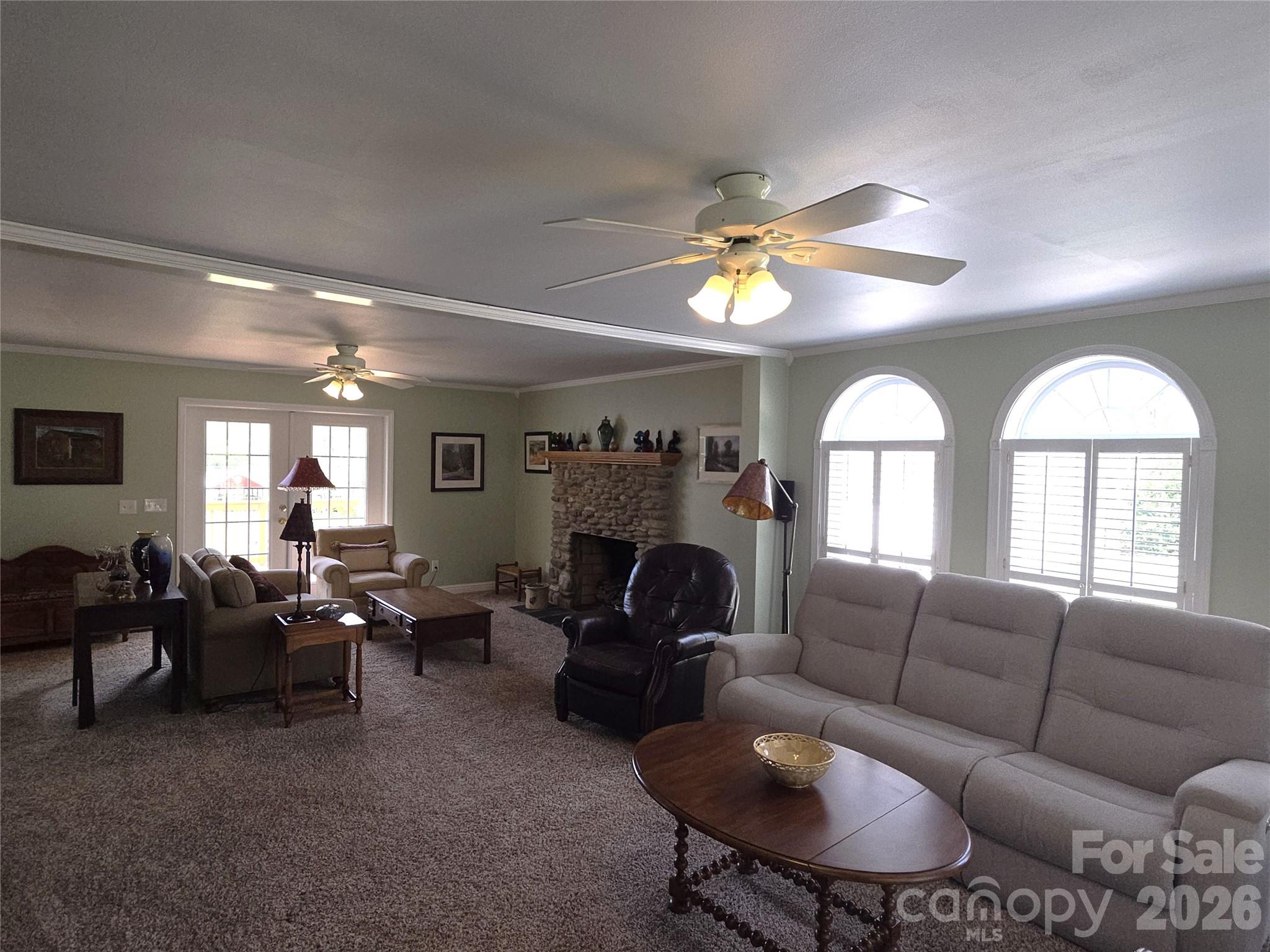 729 Sternbridge Drive Concord, NC 28025 - Photo 8 of 42 a living room with furniture a fireplace and a chandelier