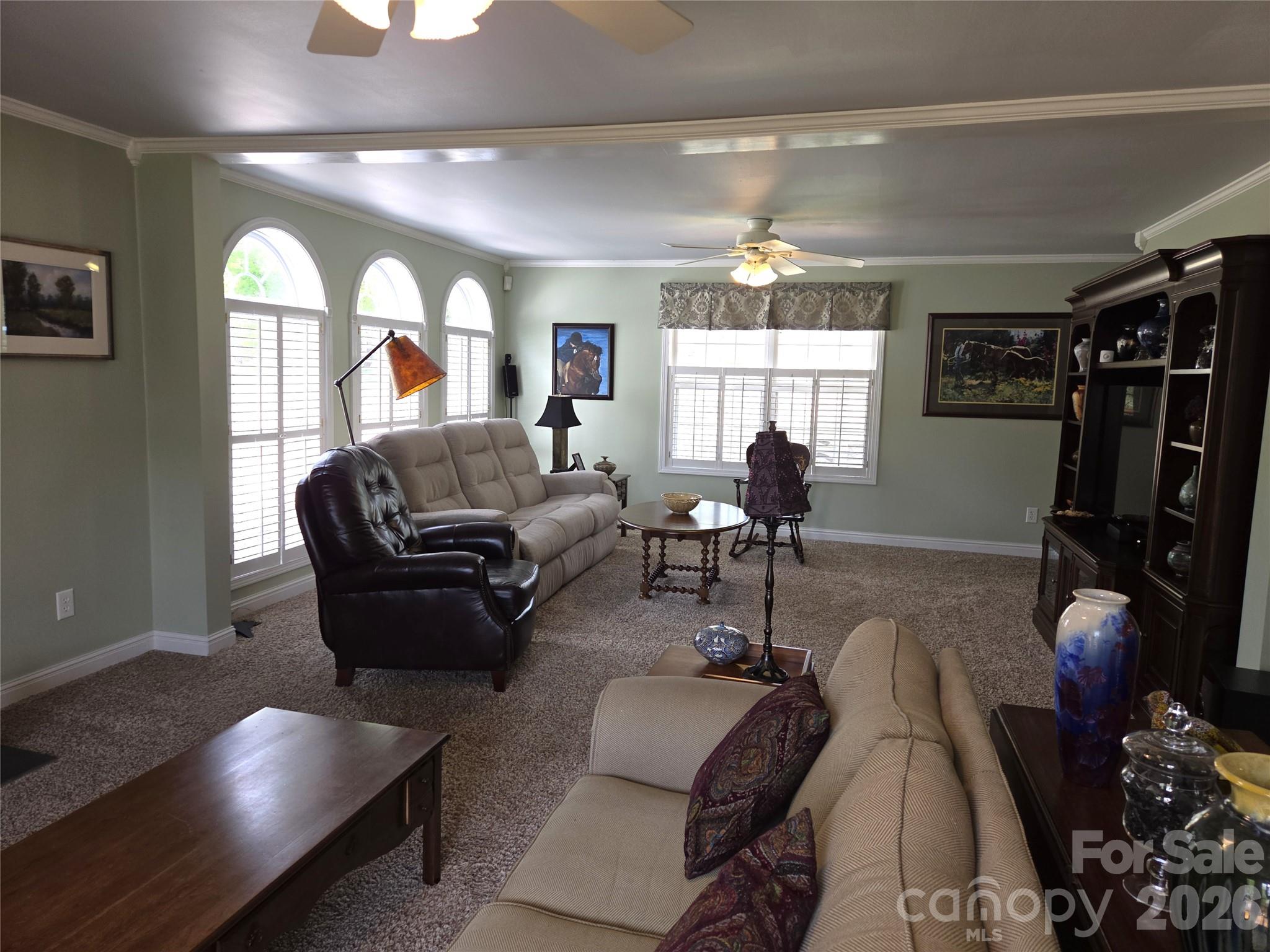 729 Sternbridge Drive Concord, NC 28025 - Photo 9 of 42 a living room with furniture a chandelier and a large window