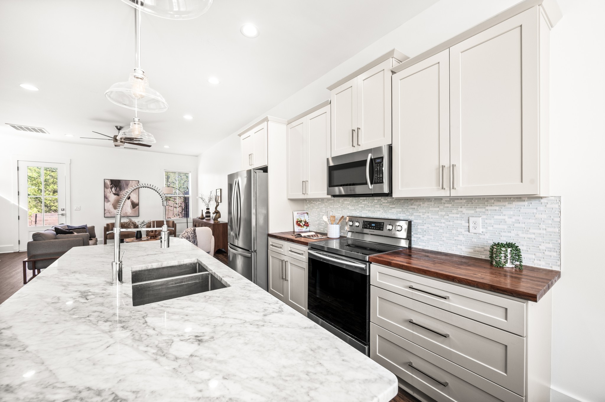 1000 Free Silver Road Nashville, TN 37207 - Photo 9 of 45 a large white kitchen with stainless steel appliances granite countertop a stove oven and a white cabinets