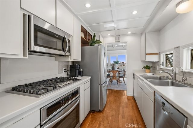 a kitchen with a stove a sink and a microwave