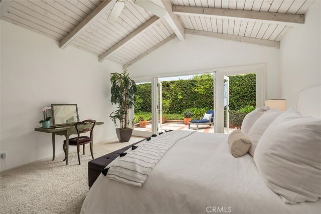 a bedroom with furniture and a large window