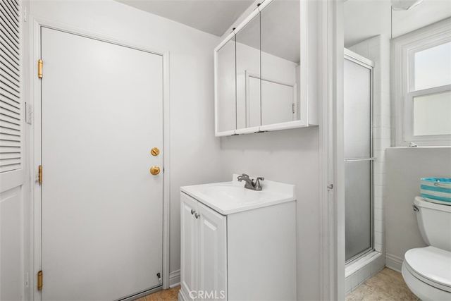 a bathroom with a sink a toilet and vanity