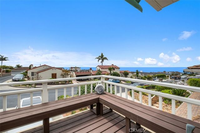 a view of a balcony with wooden floor and city view
