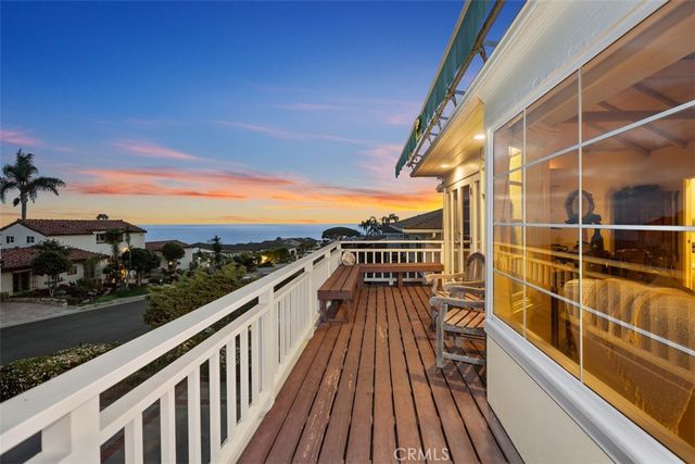 a view of balcony with a floor to ceiling window and wooden floor