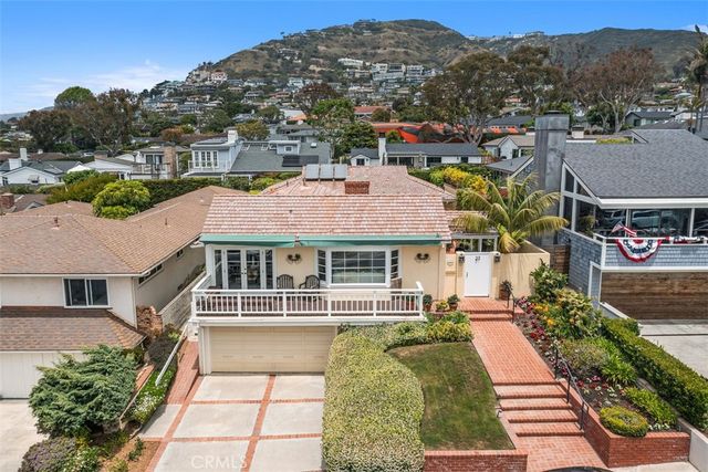 an aerial view of a house with a yard and a patio
