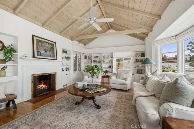 a living room with furniture a fireplace and a table