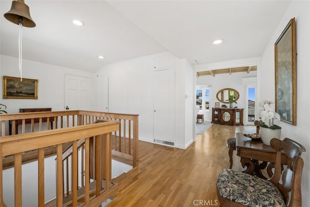 a living room with furniture flat screen tv and wooden floor