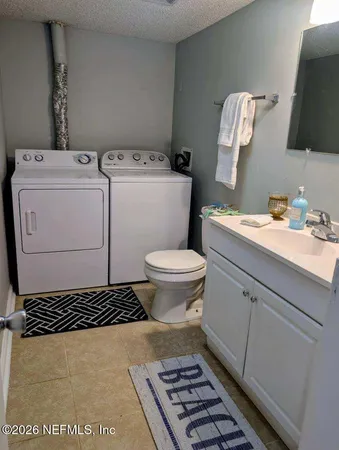a bathroom with a sink toilet and a mirror