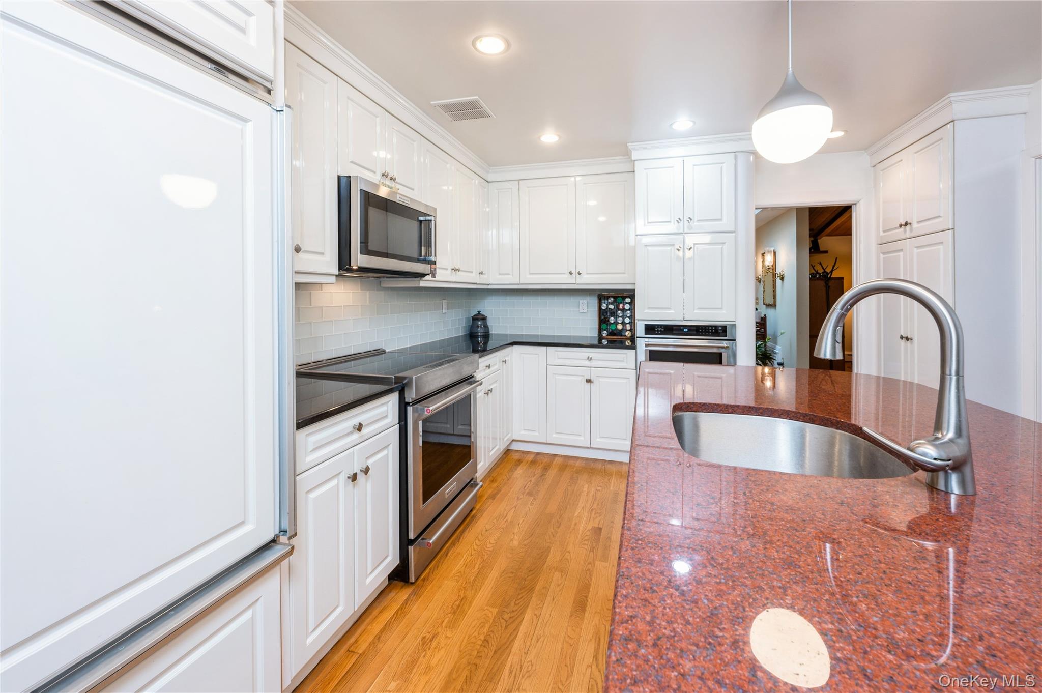 160 Hampshire Road Bronxville, NY 10708 - Photo 18 of 36 a kitchen with granite countertop a stove a sink and a microwave