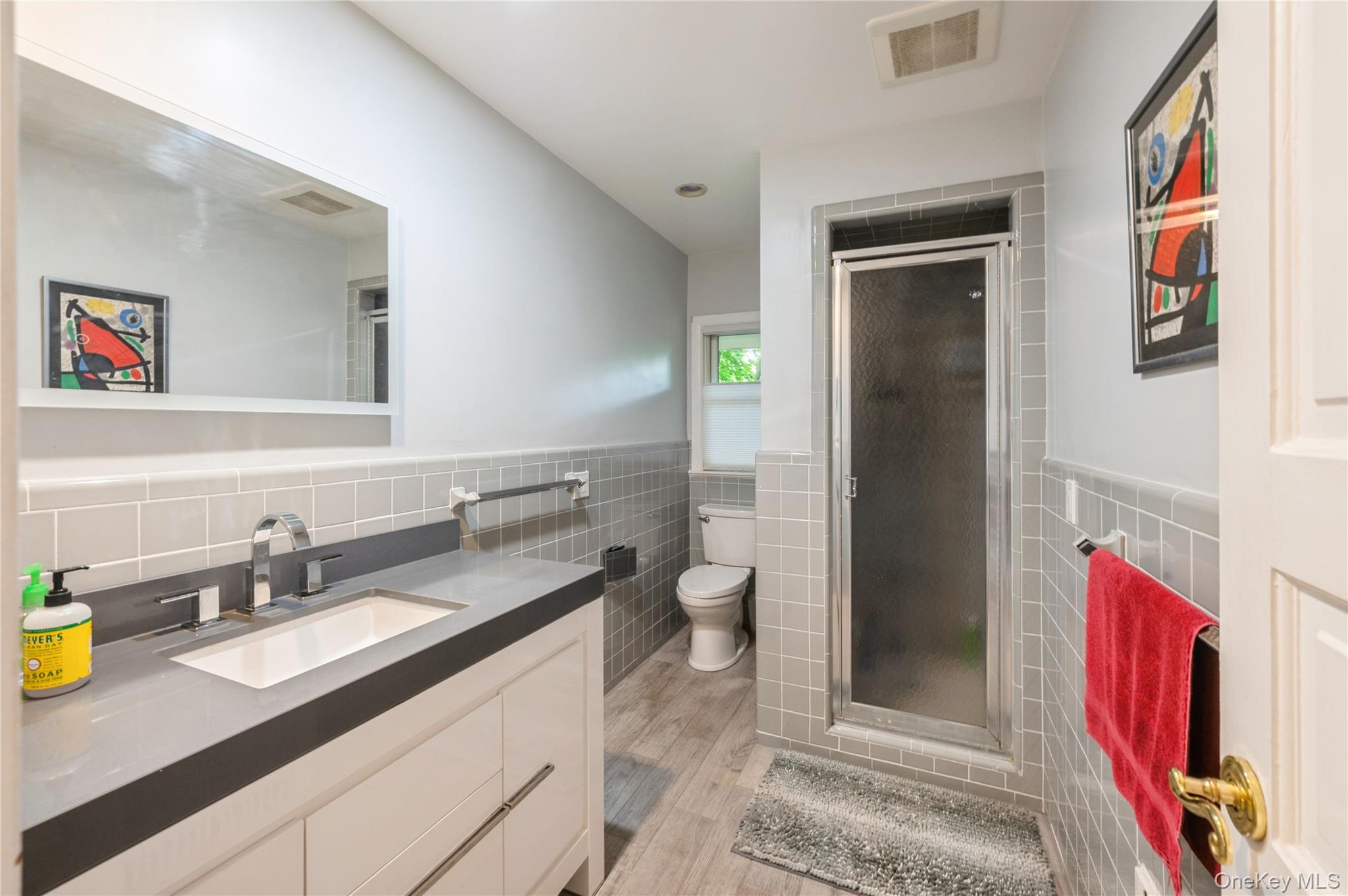 160 Hampshire Road Bronxville, NY 10708 - Photo 25 of 36 a bathroom with a granite countertop sink and a mirror