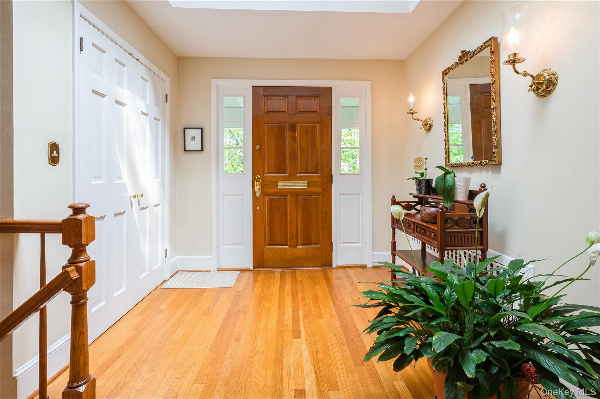 160 Hampshire Road Bronxville, NY 10708 - Photo 5 of 36 a view of a hallway with wooden floor and a potted plant