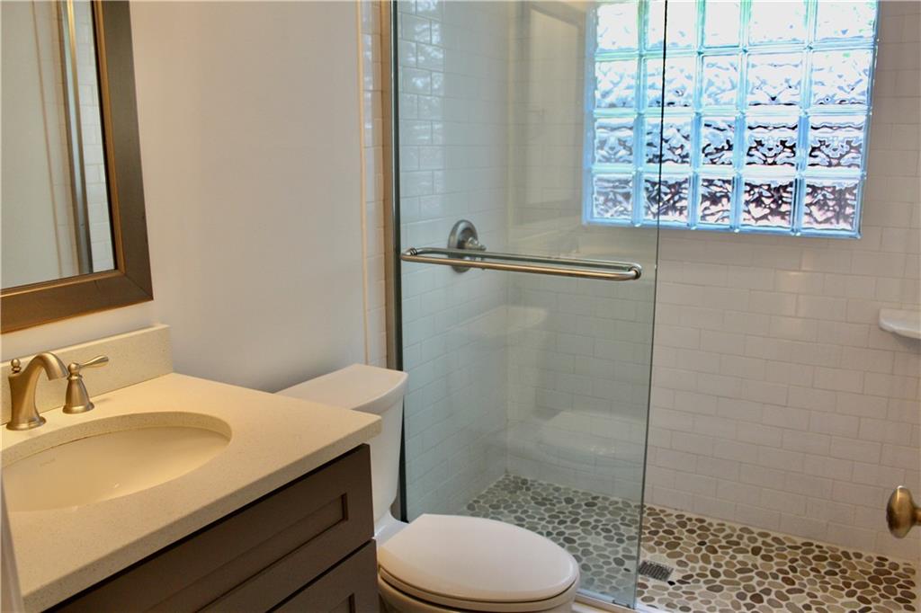 1191 Hampton Way Northeast Atlanta, GA 30324 - Photo 13 of 31 a bathroom with a sink toilet and shower